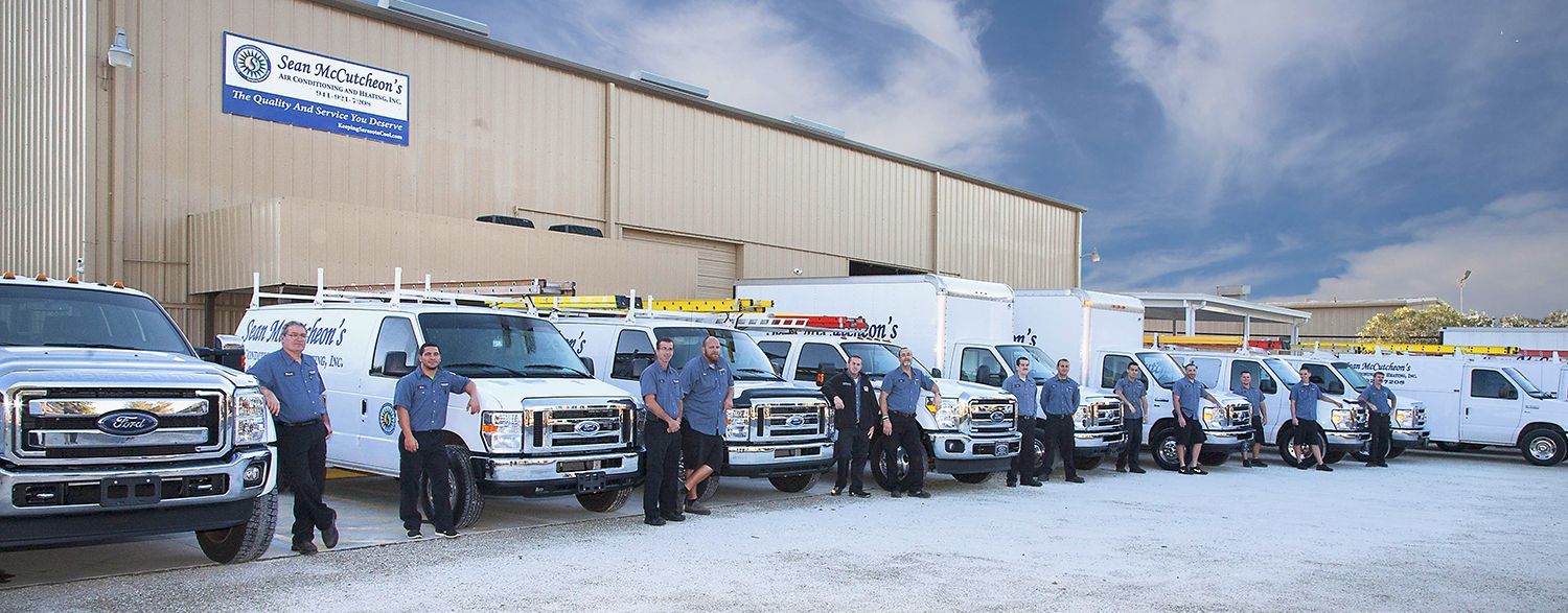 Sean McCutcheon's Air Conditioning and Heating service technicians in front of their trucks 